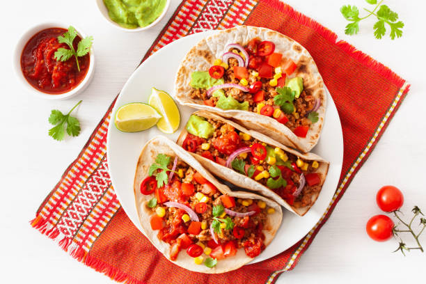 istock mexican beef and pork tacos with salsa, guacamole and vegetables 1179811734