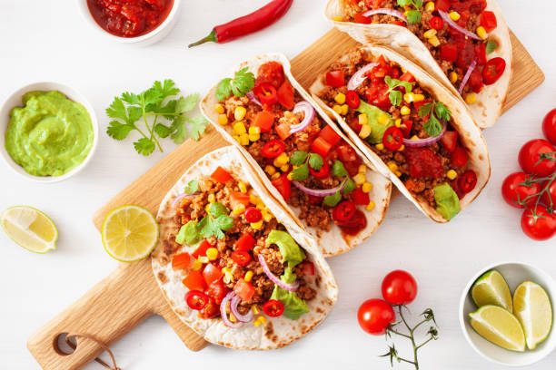 istock mexican beef and pork tacos with salsa, guacamole and vegetables 1179812601