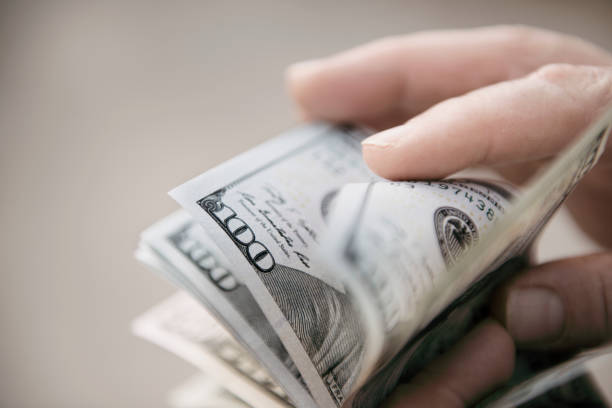 istock Unrecognizable mature man counting USA Dollar bills 1179812652