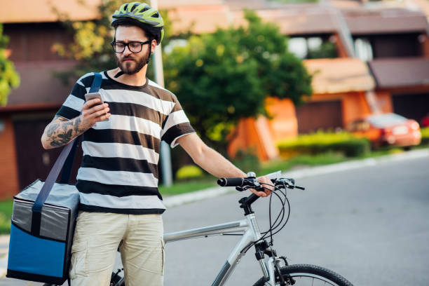 istock Delivery guy looking at phone 1179813093