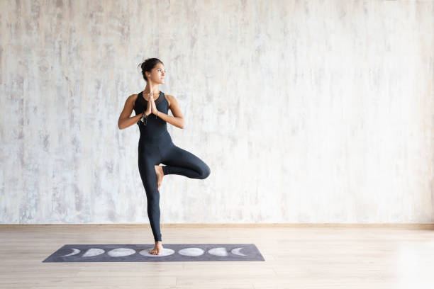 istock Brunette woman yoga instructor doing vrikshasana 1179814927