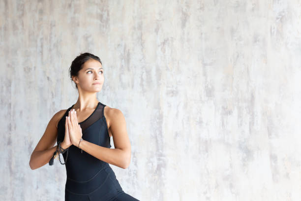 istock Brunette woman yoga instructor doing vrikshasana 1179815042