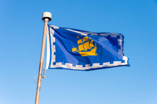 istock Quebec city flag over blue sky 1179815175