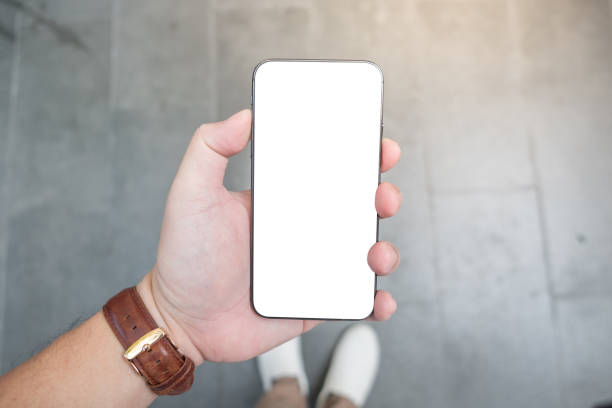 istock A man hand holding smart phone with blank screen. Mockup screen. 1179816056