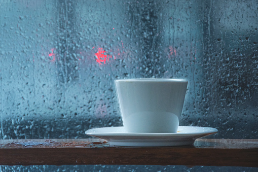 enjoying coffee on rainy day