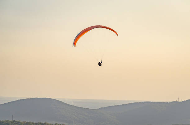 istock Paragliders soar in the sky 1179818630