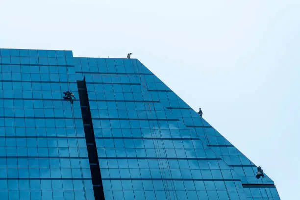 Photo of Building cleaning staff on top the building