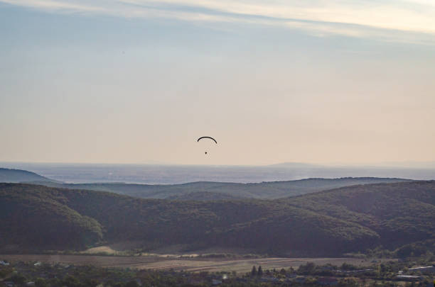 istock Paragliders soar in the sky 1179821695