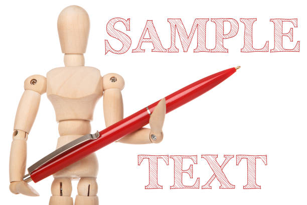Small wooden dummy and ballpoint pen on white background