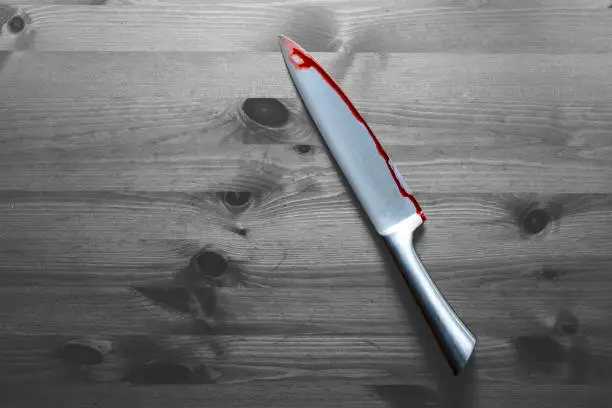 Photo of knife with grunge of blood on wood floor, halloween bloody murder or death crime killer violation concept. Black and white