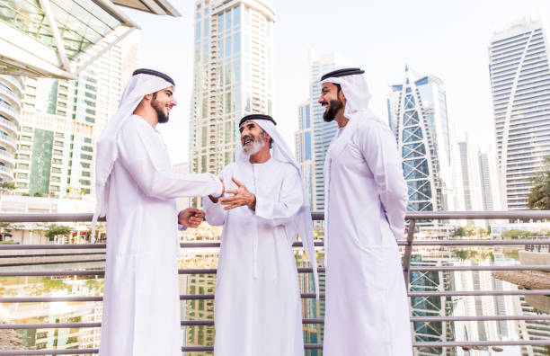 istock Three business men walking in Dubai wearing traditional emirati clothes 1179824607