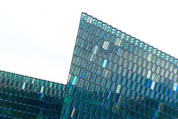 Reykjavik, Iceland: A close-up shot of the Harpa Concert Hall, opened in 2011. The glass-fronted building, located in the Old Harbor, has won the Mies van der Rohe for architecture. Copy space in the white sky background.