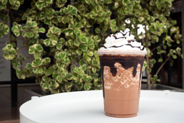 mocha  frappe in plastic cup with whipping cream and chocolate sauce topping. - latté cafe macchiato cappuccino cocoa imagens e fotografias de stock