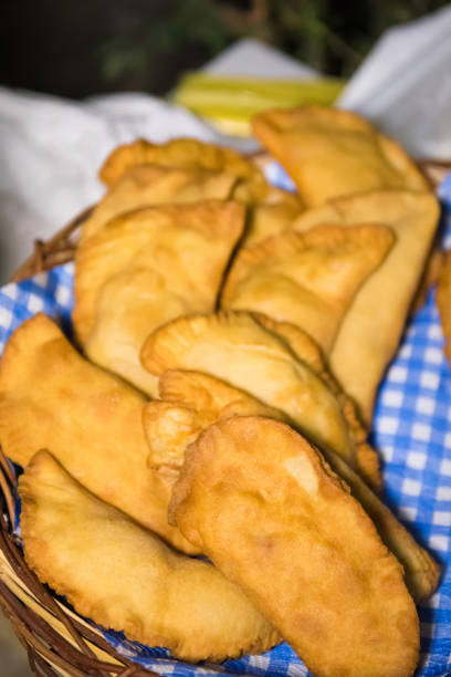 istock Apulian food: fried pies called panzerotti in a basket, made with tomato sauce, mozzarella and prosciutto, close-up 1179830444