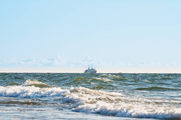 the ship sails on rough seas near the shore