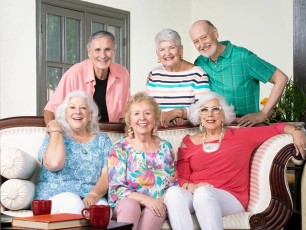 istock Six Senior Friends Around a Couch 1179835135