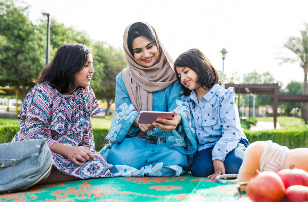 istock Mom and daughters spending time together at the park, in Dubai 1179837596