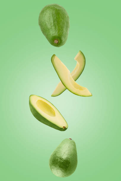 Sliced Avocado isolated in green surface viewed from above stock photo