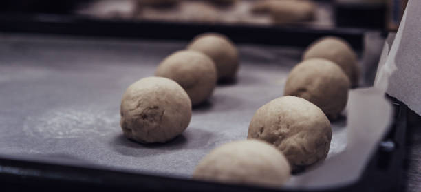 istock Small Bread Dough Balls Placed on Cooking Paper on Pan 1179839812