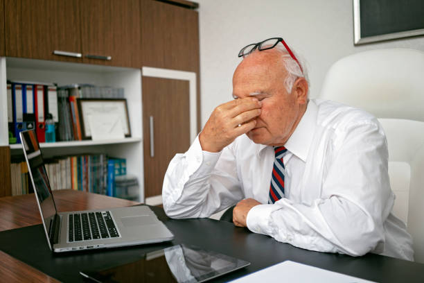 istock Senior man feeling tired, working on laptop. 1179840506