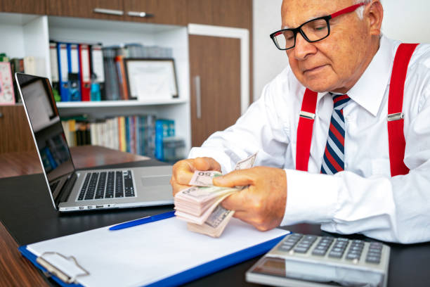 istock Senior business man counting money. 1179841264