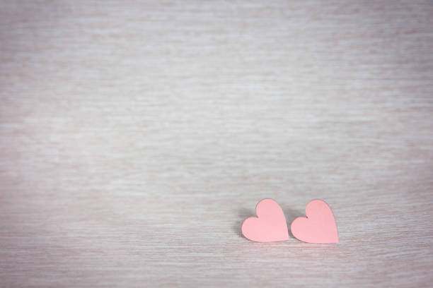 istock Two hearts. Background for congratulations with pink hearts 1179842627