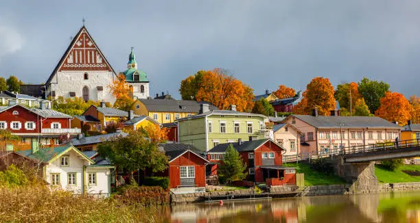 This pic shows Beautiful old city landscape with idyllic river and old autumnn colors at daytime  in Porvoo. The pic shows colorful wooden houses and maple trees. The pic is taken on 8th october 2019 in Porvoo finland.