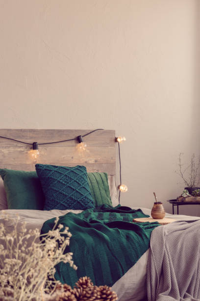 istock Copy space on empty grey bedroom with fashionable bed with emerald green and grey bedding 1179846421