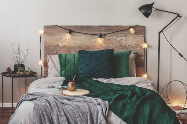 istock Yerba matte on wooden plate on king size bed with grey bedding and emerald grey blanket 1179846427
