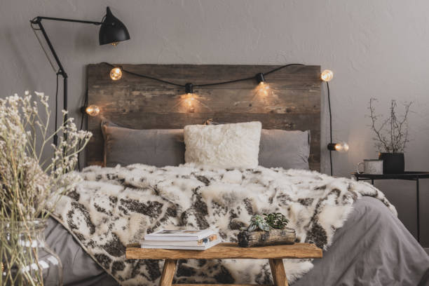 istock Flower and coffee mug on industrial bedside table next to king size bed 1179846491
