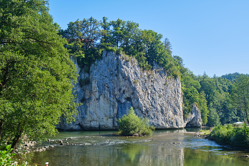Rock formation and Crisul Repede river at Suncuius village, Bihor county, Romania, on a bright sunny day.