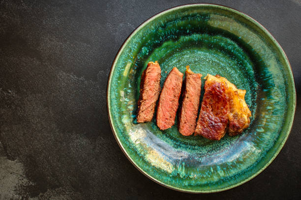 istock beef steak fried grill (delicious meat, sliced ​​portion serving, roast rare) menu concept. food background. copy space. Top view 1179847646