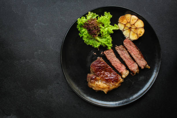 istock beef steak fried grill (delicious meat, sliced ​​portion serving, roast rare) menu concept. food background. copy space. Top view 1179847650