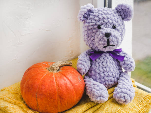 istock Bright plush toy sitting on a windowsill 1179848396