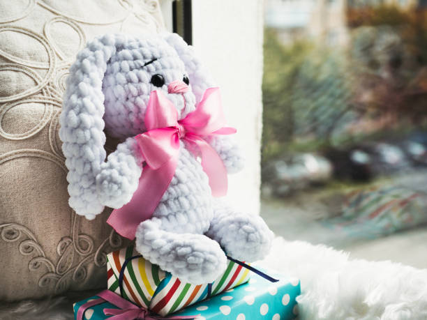 istock Bright plush toy sitting on a windowsill 1179848541