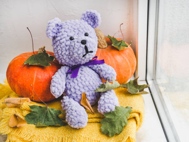 istock Bright plush toy sitting on a windowsill 1179848681