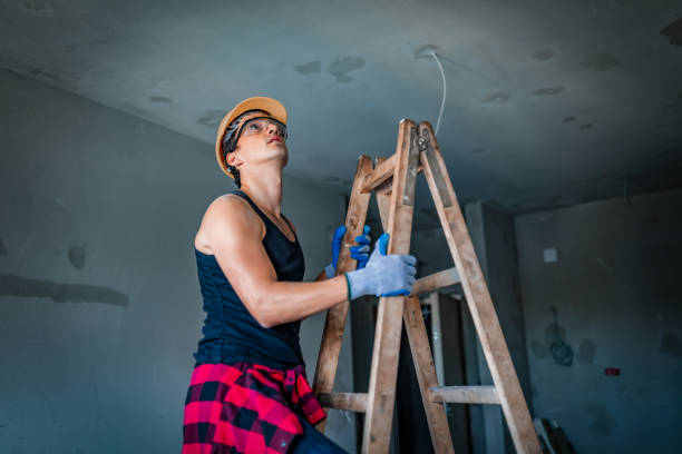 istock manual worker moving up the ladders at construction site 1179852536