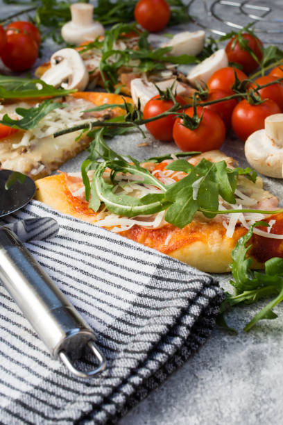 istock Homemade pizza with rucola and cherry tomatoes. 1179853981