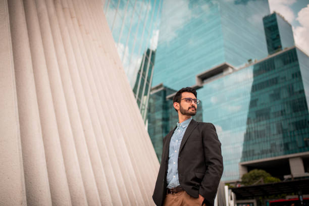 istock Businessman standing outside the office building 1179856322