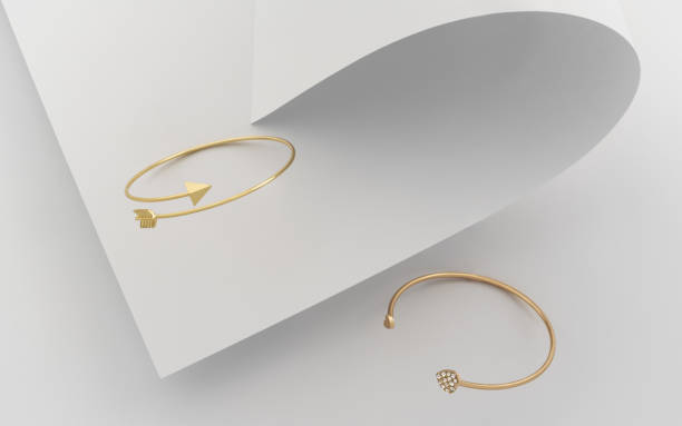 istock Arrow and heart shape modern golden bracelets on folded paper 1179856823