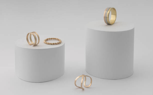 Golden rings collection on white cylinders paper platforms Golden rings collection on white platform ring jewelry photos stock pictures, royalty-free photos & images