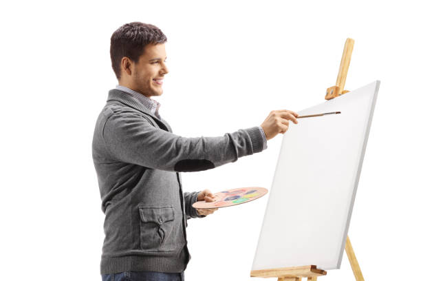 istock Young man painting on a canvas 1179857879