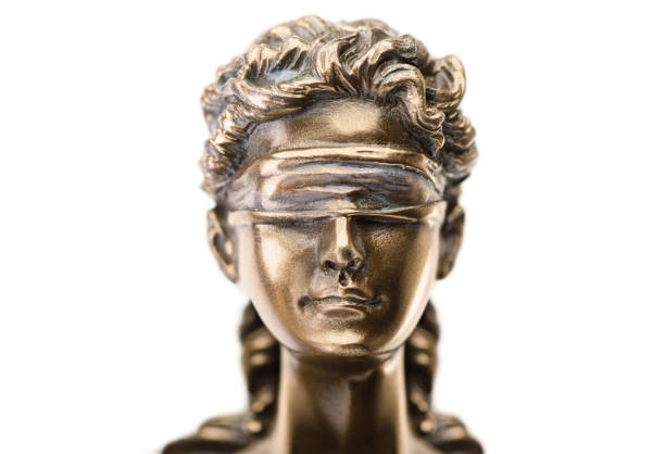 istock Close up statue of justice isolated on white background 1179860141