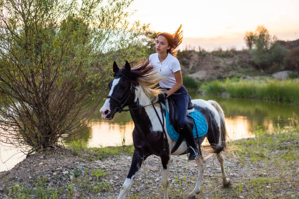 istock Girl galloping with her pinto horse 1179860578