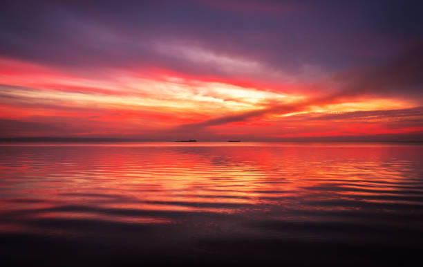 istock Fiery dramatic landscape with the sea, beautiful sky and ships. Dawn. small waves, almost calm. 1179861726