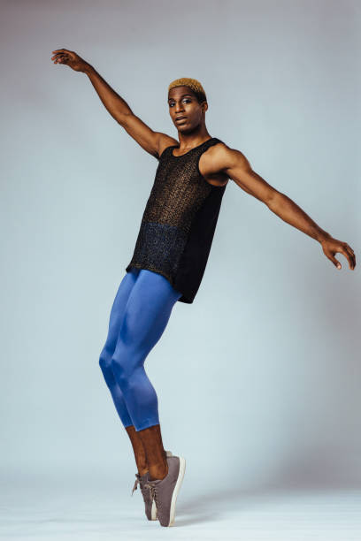 Portrait of a young man dancing ballet in studio Portrait of a young man dancing ballet in studio black man blonde hair stock pictures, royalty-free photos & images