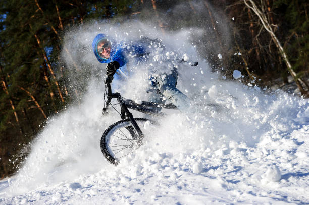 Biker preparing for downhill in the forest. Cloudy winter day. Film look image.
