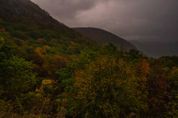 Moody dark autumn evening at Storm King Park featuring stormy sky on the background and mountains on the foreground