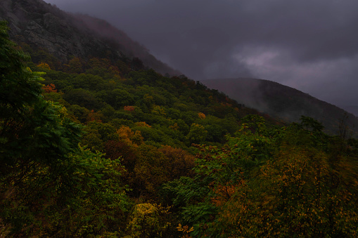 Moody dark autumn evening at Storm King Park featuring stormy sky on the background and mountains on the foreground