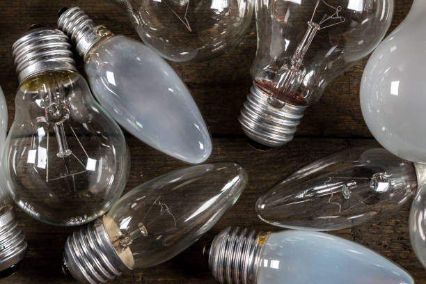 istock Lightbulbs on wooden background 1179870669